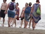 Mature walking naked in public on the beach