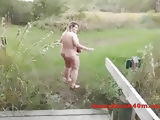 Huge tits woman naked by the swamp