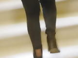 Sexy woman goes up the stairs of high school